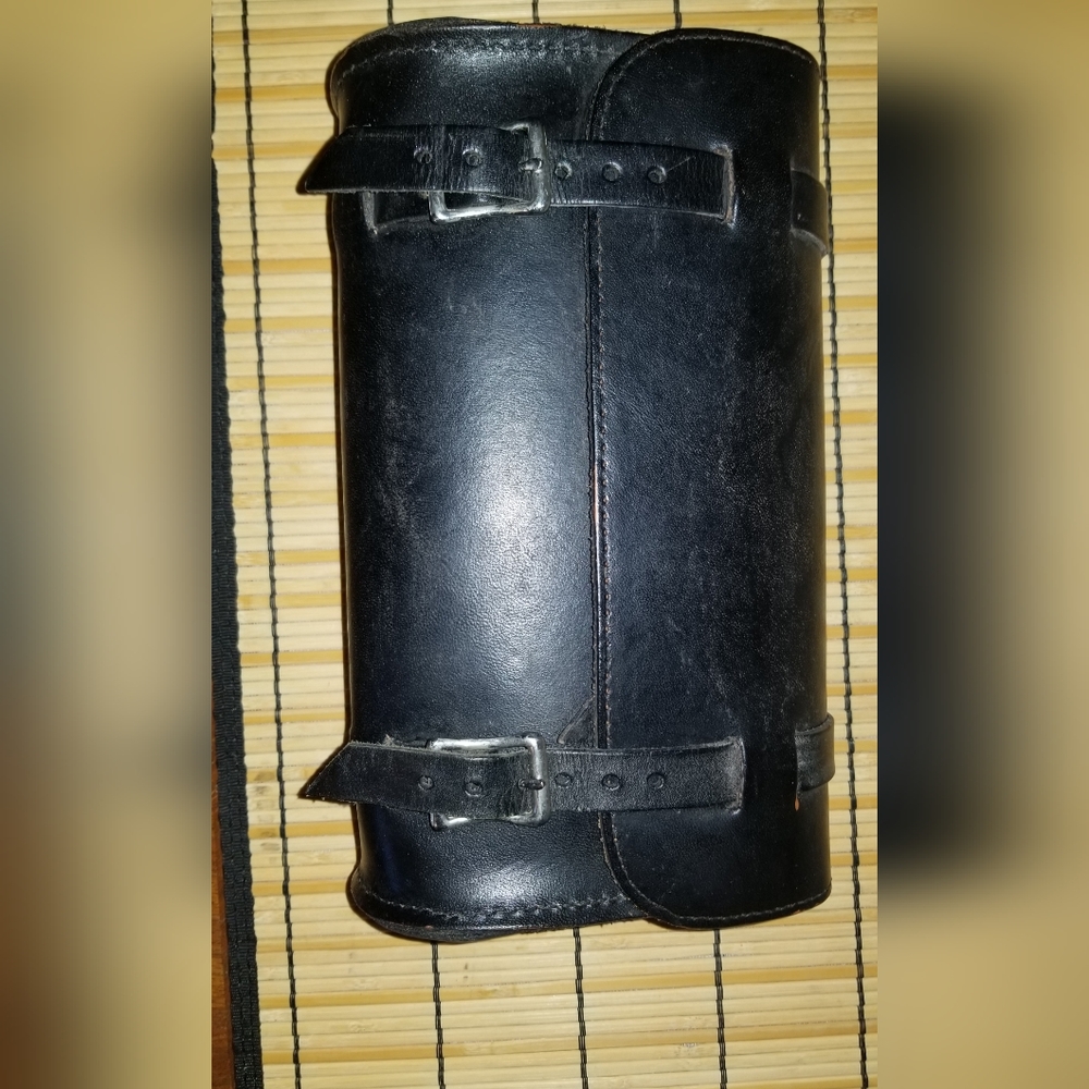 Black leather bag 9.5Lx5.5Hx3.5W & 2 straps 22" long with 8 adjustment holes.
